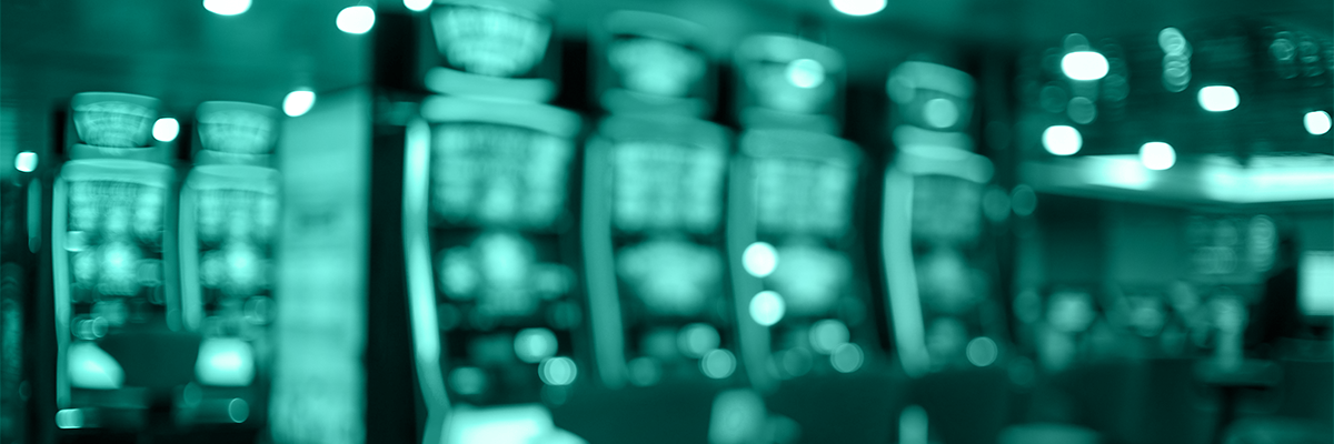 Progressive betting system — row of slot machines in a casino setting