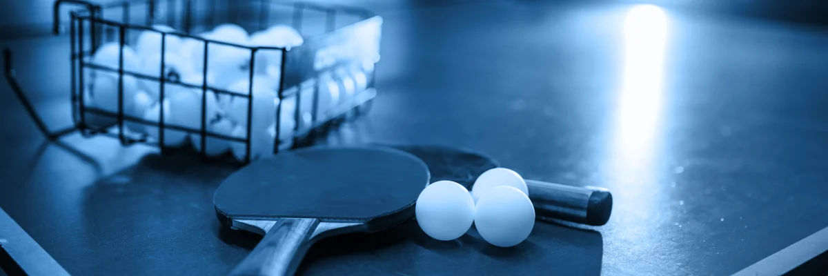 Table tennis match with live crypto betting markets displayed nearby